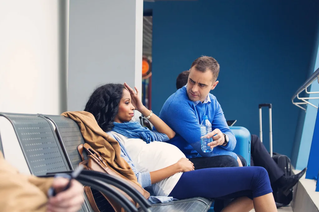 Pregnant woman and man in a doctor surgery waiting room