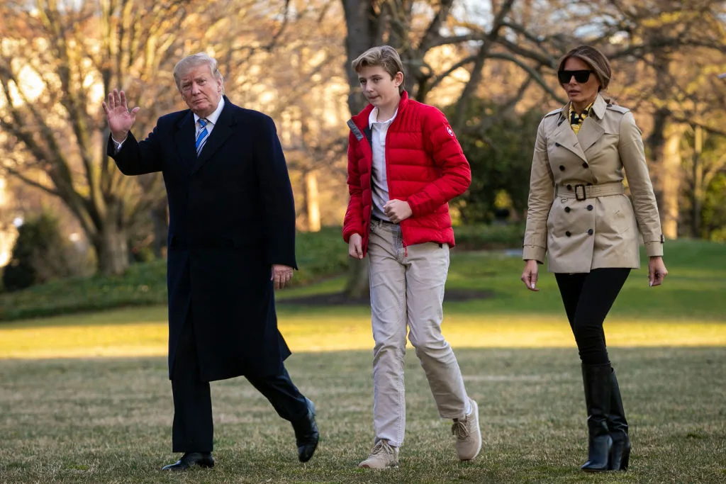 President And Mrs Trump walking with their son Barron Trump on the South Lawn of the White House