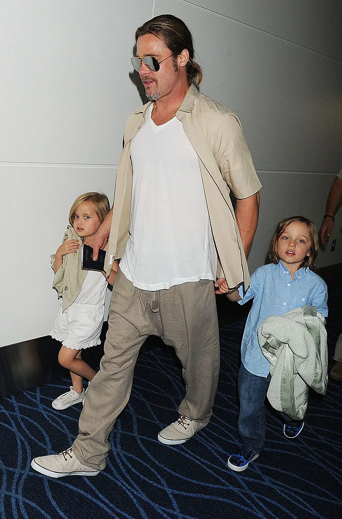 Brad Pitt, Knox Jolie-Pitt and Vivienne Jolie-Pitt pictured in Tokyo, Japan in 2013