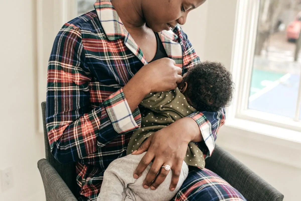 A woman breastfeeding a young child