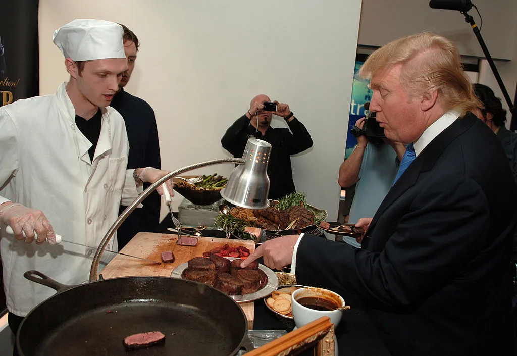 Donald Trump pointing at a steak