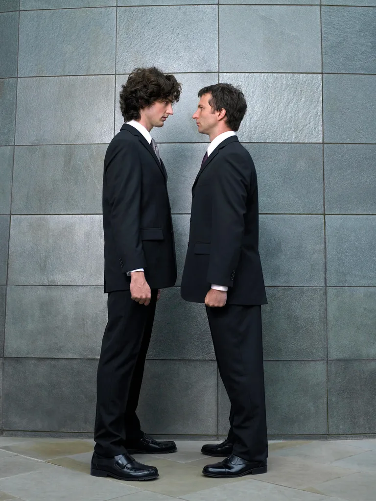 Two men in suits staring at each other