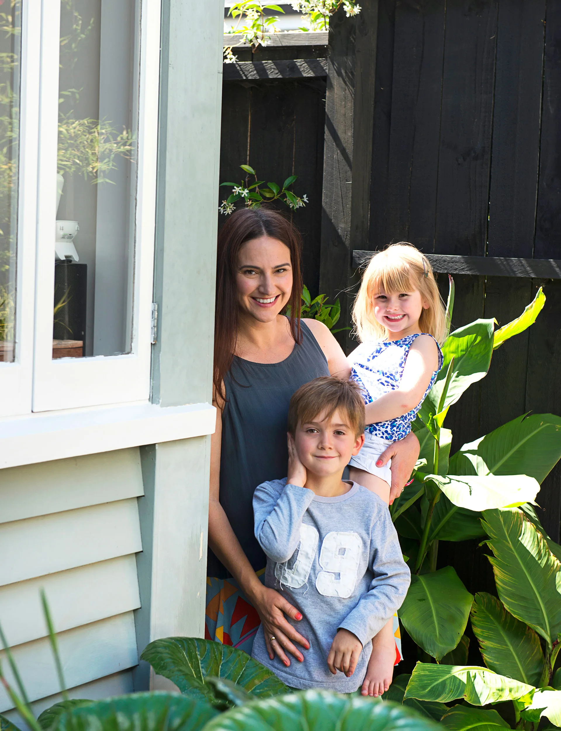 Claire, Thomas and Molly love the luscious leaves of the ligularia and canna.