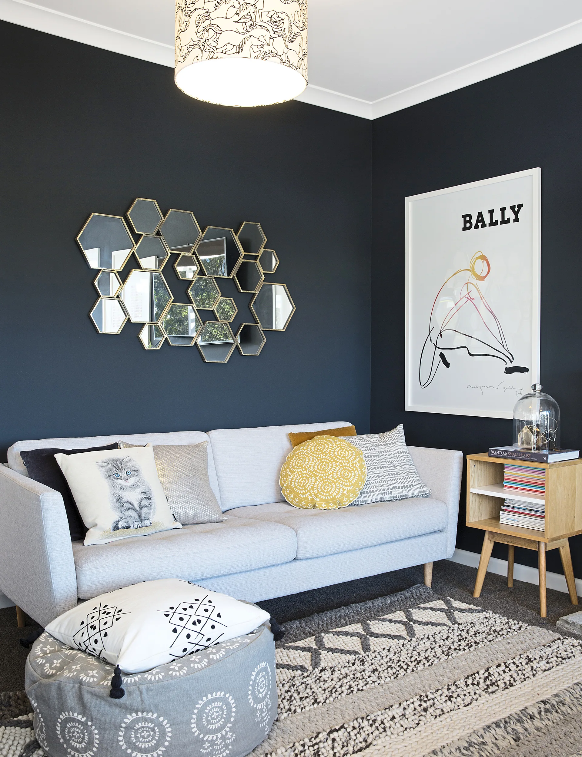 The living area is flooded with natural light, so Vanessa opted for a deep shade on the walls to offset some of the brightness. Visitors always ask what colour it is because it seems to change from black to charcoal to navy, depending on the light. 