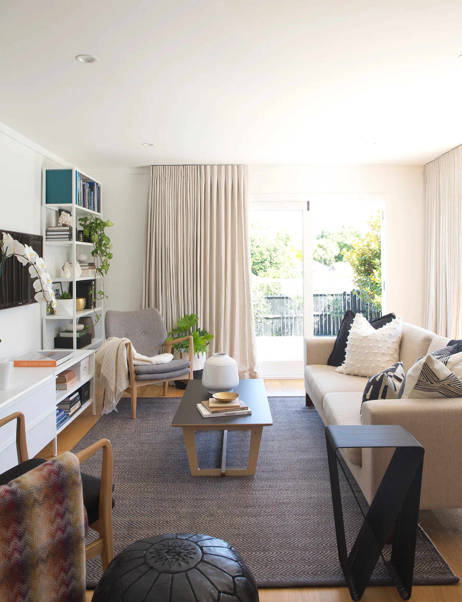 The living area now flows seamlessly out onto a brand-new deck, connecting directly with the back lawn. 