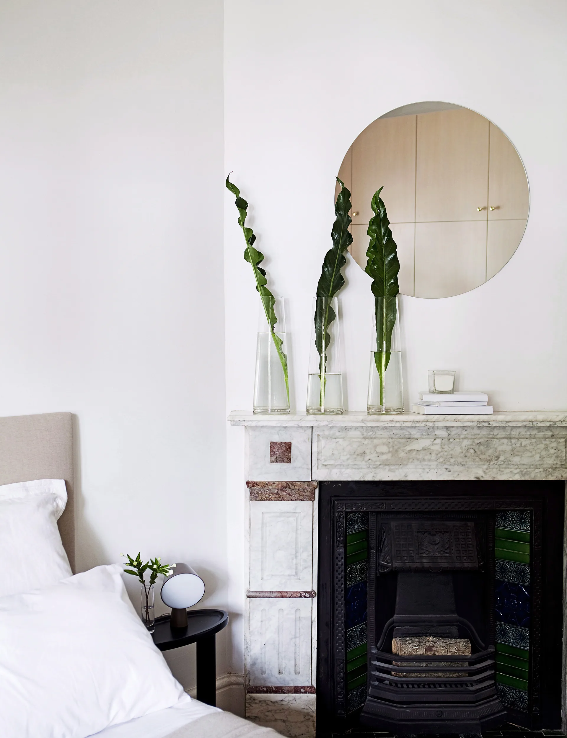 The colour scheme of the room echoes the neutral tones found in the fireplace and marble surround.