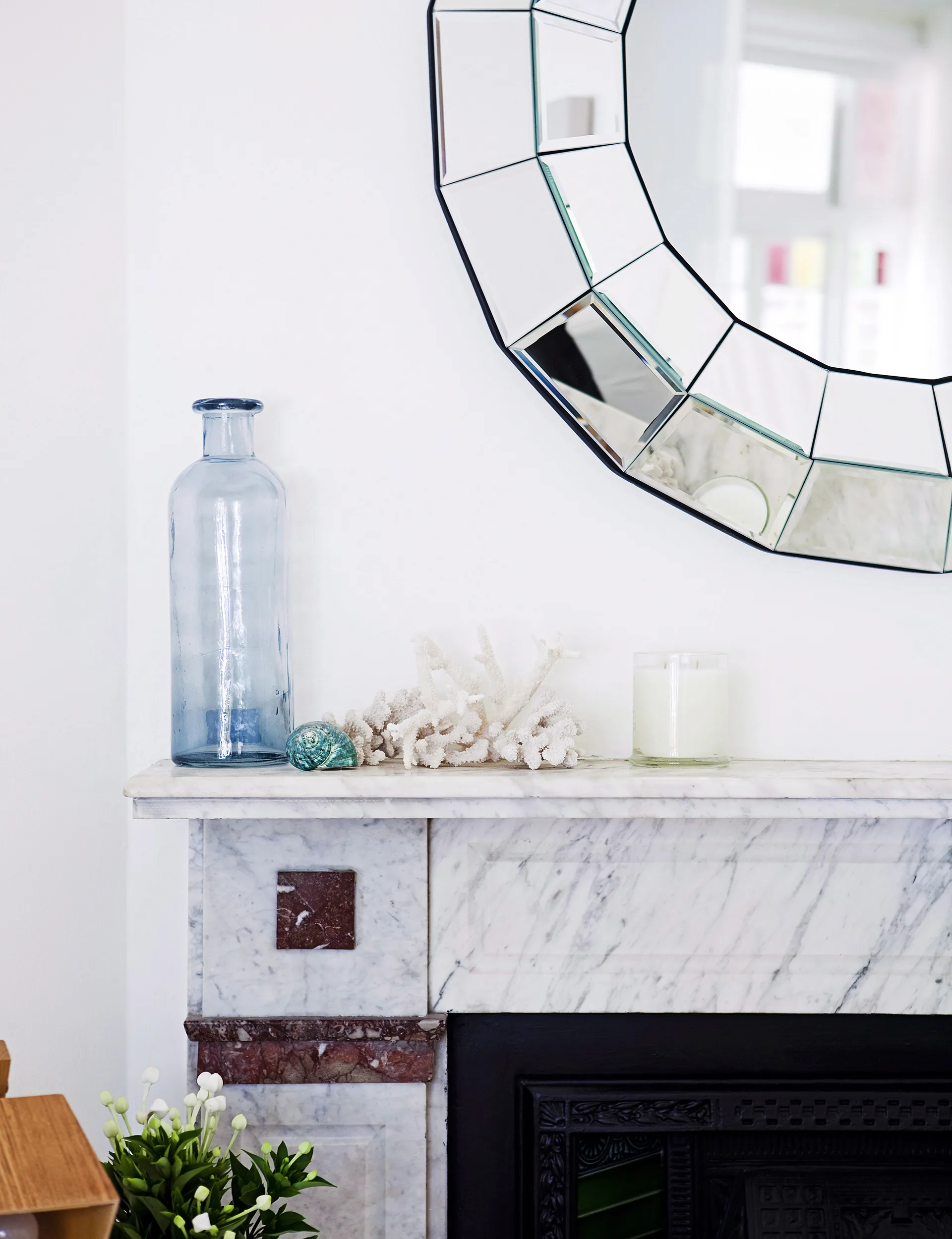 A beautiful mirror hangs above the mantel salvaged from a heritage home.
