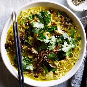 Bowl filled with our best chicken noodle soup recipe topped with fried shallots and coriander leaves