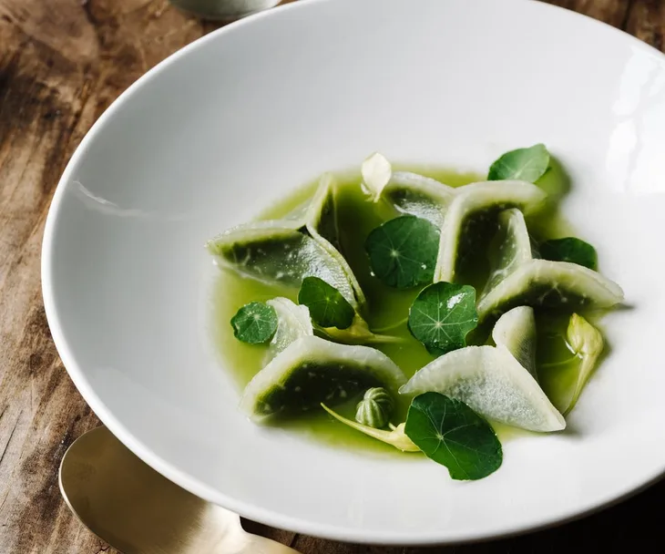 Alla Wolf Tasker&rsquo;s kohlrabi dumplings with sunflower seed pesto and apple consomm&eacute;