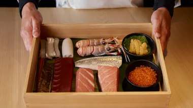 A wooden tray displaying cuts of raw fish, skilfully prepared by the chefs at Sushi Room, Brisbane.