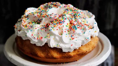 Ciaramicola cake topped with Italian meringue and sprinkles