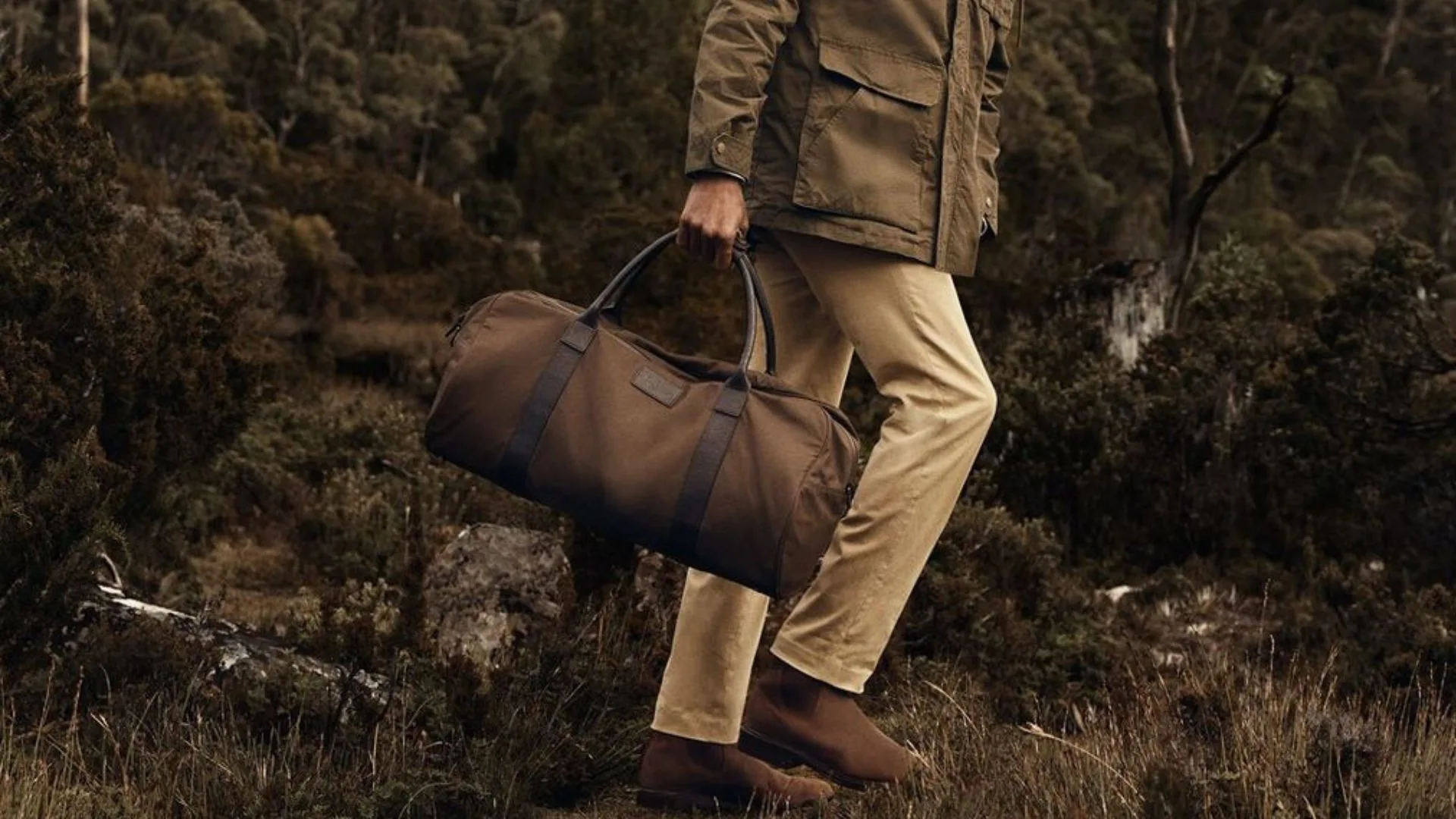 RM Williams bag held by a man in nature