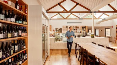 Man walking through Otherness wine bar with A-frame roof