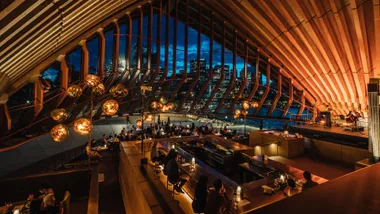 Bennelong bar interior with people dining to depict the best Sydney happy hours