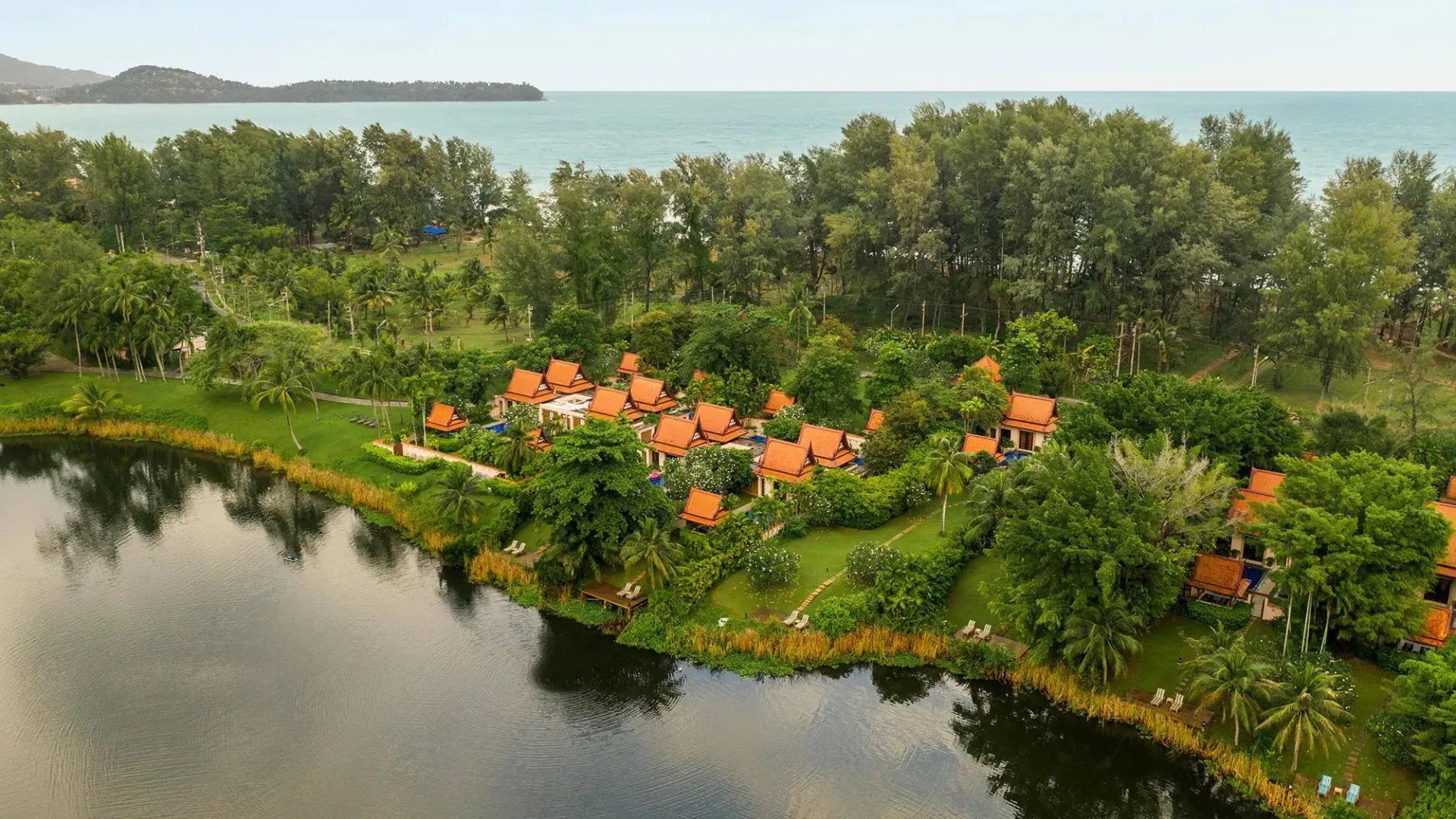 Villas surrounded by greenery line the picturesque lagoon at family-friendly Phuket resort Banyan Tree.