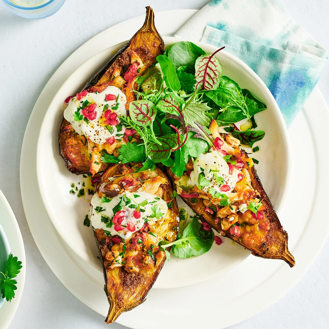 Stuffed eggplants filled with shredded chicken and topped with mozzarella and herbs