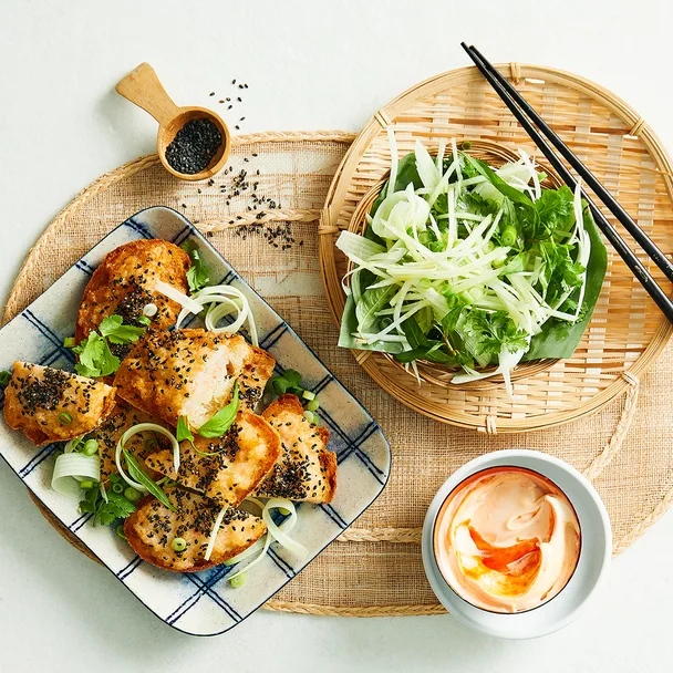 Prawn and crab toast with a herb salad and sirarcha mayo with spoon of black sesame seeds.