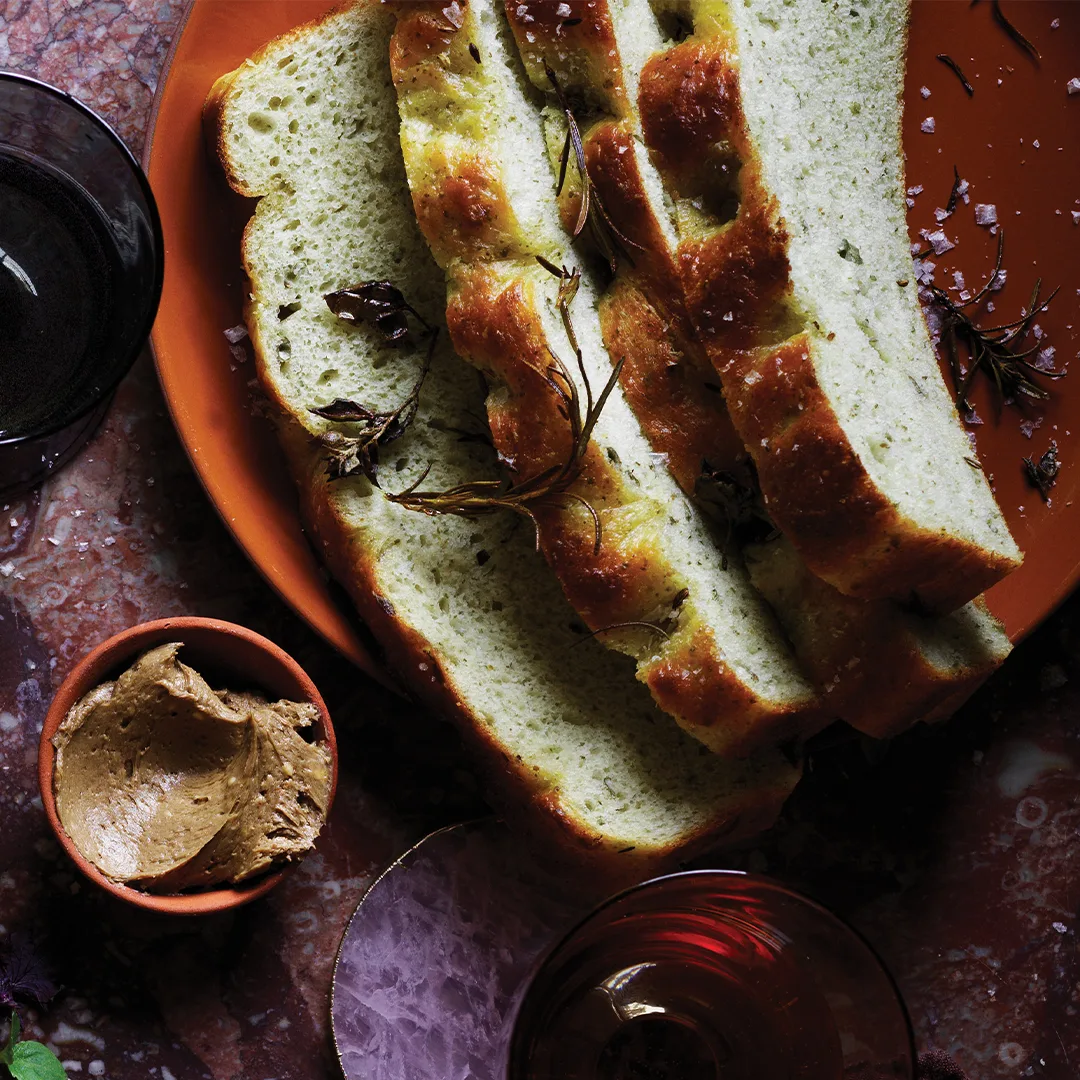 Slices of potato focaccia with black garlic butter