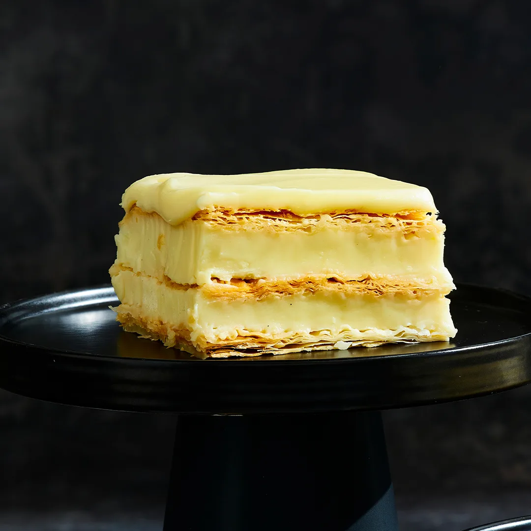 Yuzu and vanilla slice on black cake stands.