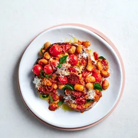 Beans and chorizo on toast on white plate.