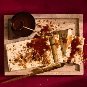 Bread and butter ice-cream with warm salted fudge on tray.