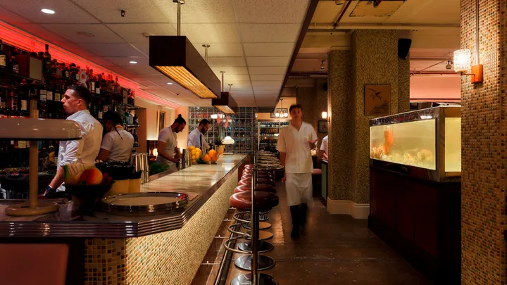 Merivale's Good Luck Restaurant Lounge bar in Sydney CBD with bar staff and waiter walking towards camera