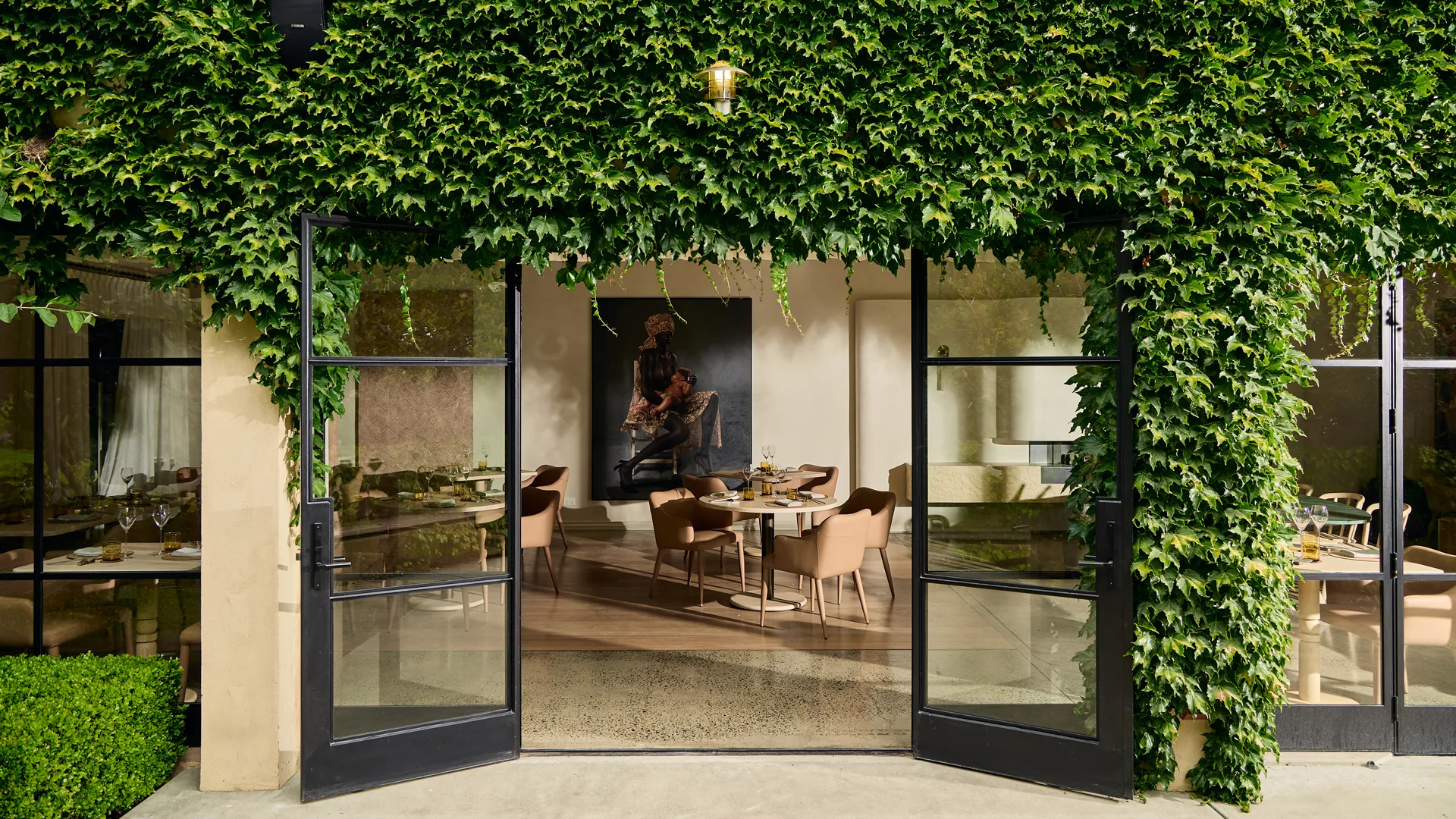 Ivy-covered entrance to LVN Restaurant at Adelaide Hills winery Bird in Hand, showing a peek into the smart, light-filled dining room