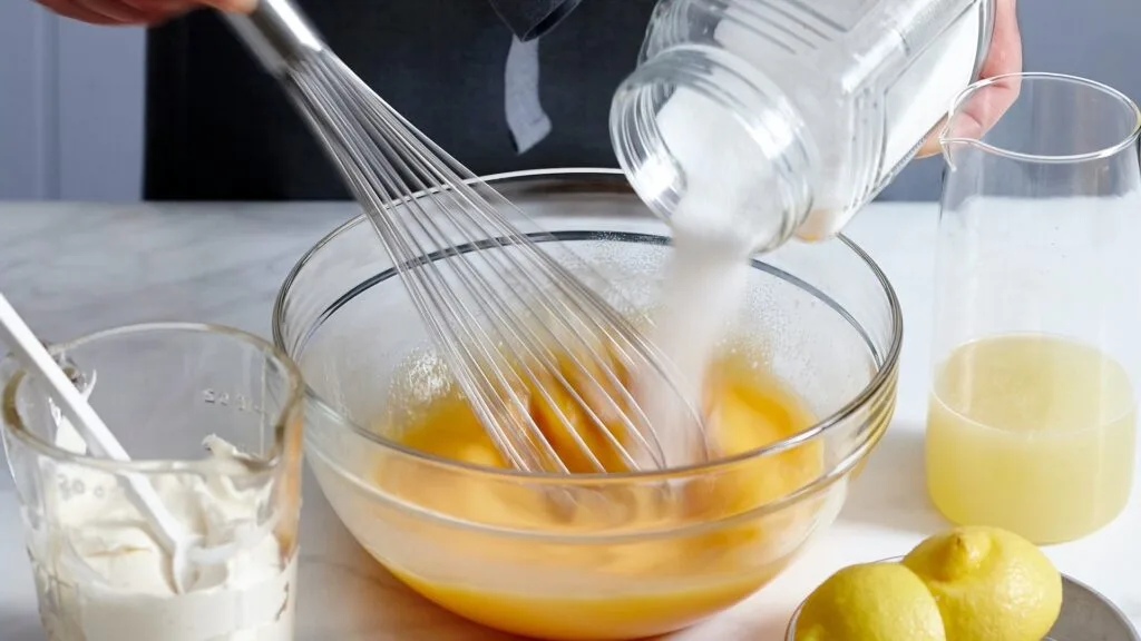 A lemon tart filling starts with making a basic custard, then letting it stand before adding lemon.