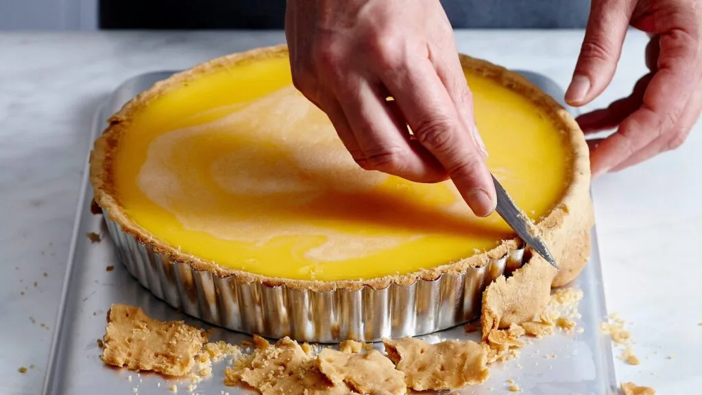 Trimming pastry when it is still warm helps prevent cracks and makes it easier to get an even edge.