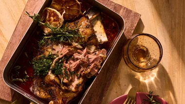 slow cook lamb with rosemary pesto in baking dish.