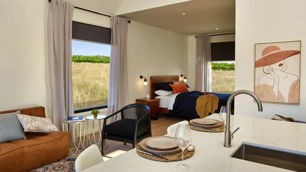 The living room and bed at the Vineyard Cottage at Glenbosch Wine Estate.