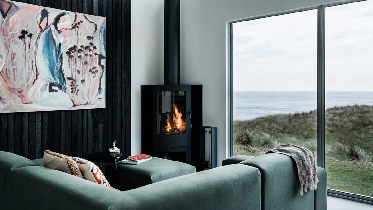 Living room with scenic outlook and fireplace at Kittawa Lodge