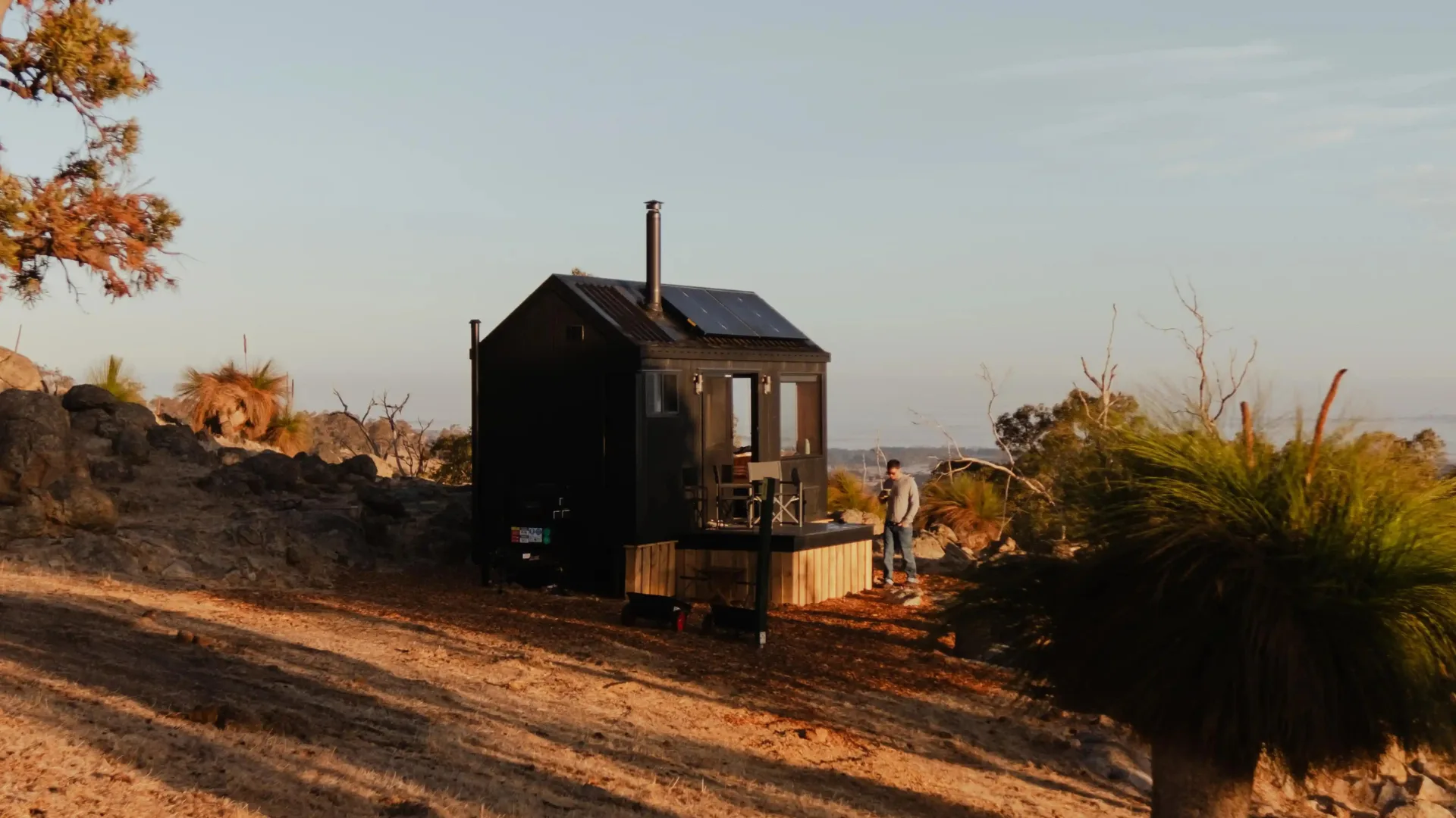 Exterior of Unyoked tiny home in WA with man standing out front