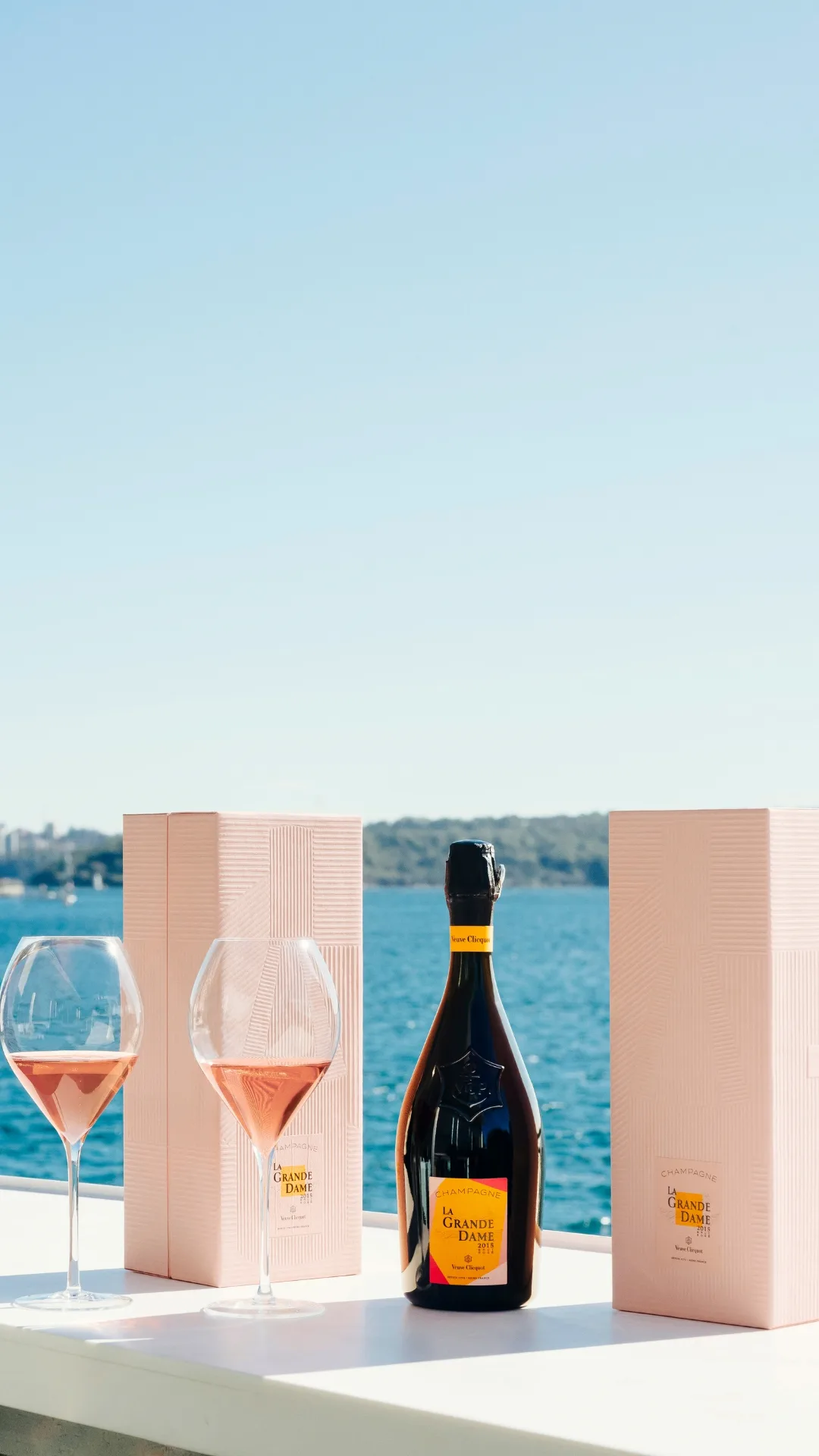 Glasses of Veuve Cliquot with a ocean backdrop.