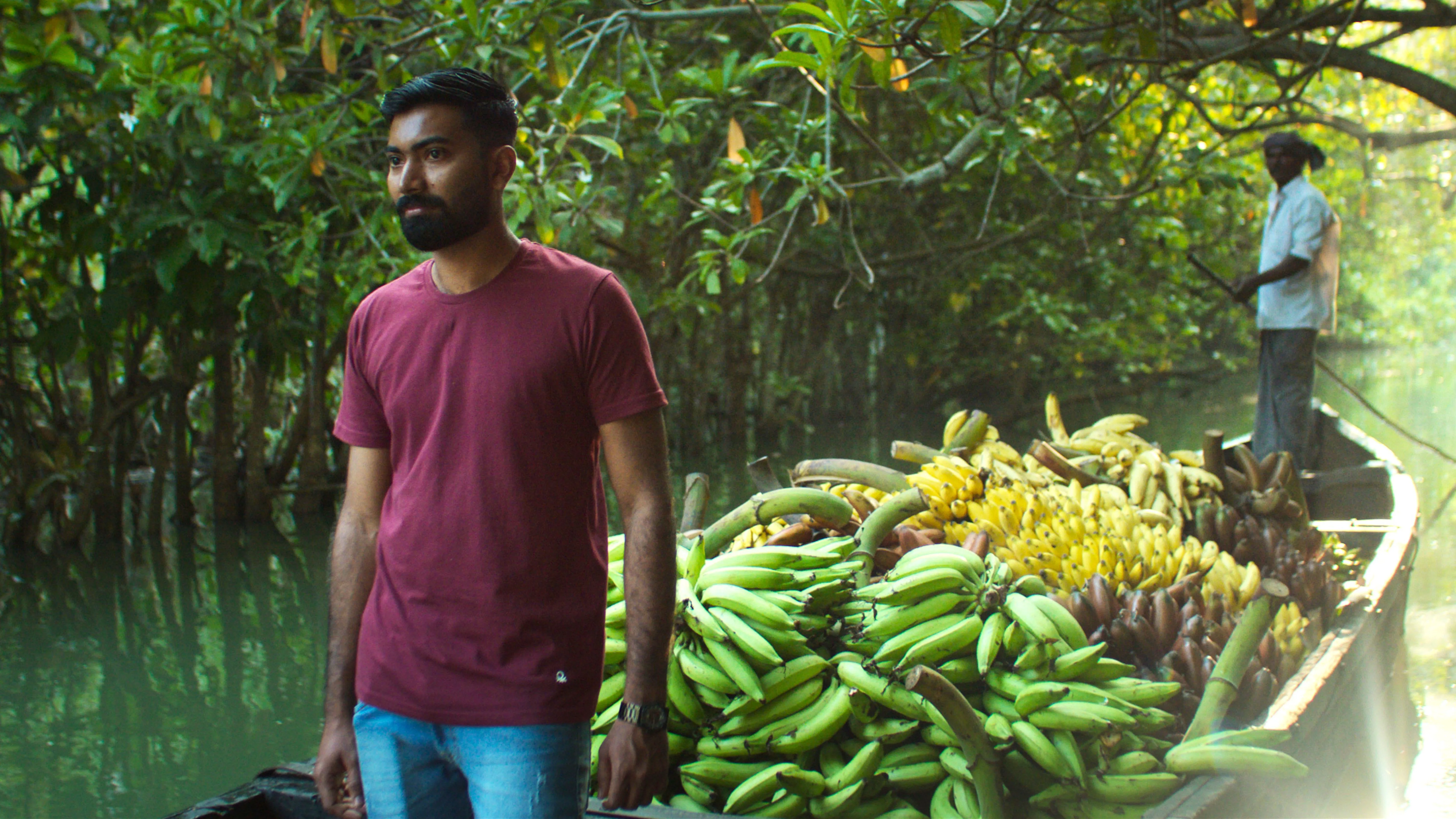 Abaneesh Sahadevan Nair on a boat with bananas in Kerala, India, as featured in Apple TV show Omnivore.