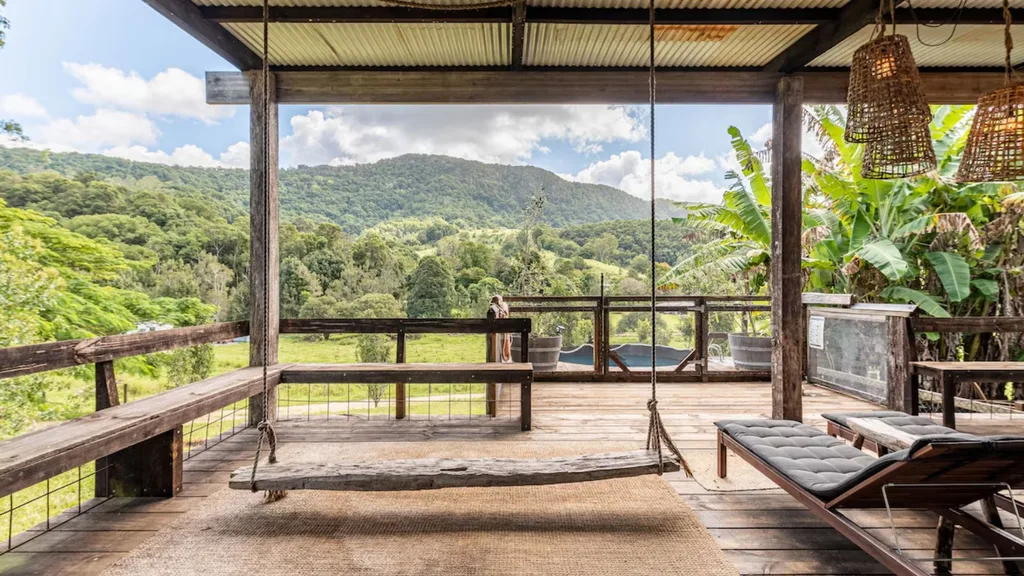 deck with swing and plunge pool looking out to rainforest