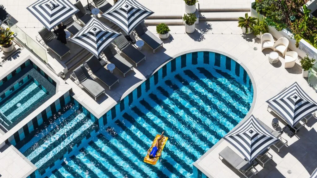 woman floating in QT gold Coast pool