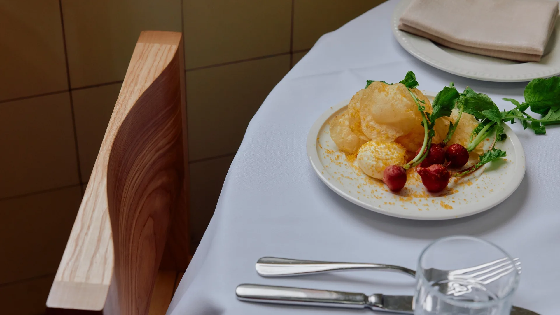 A plate of radishes from Julie on a table with a white tablecloth.