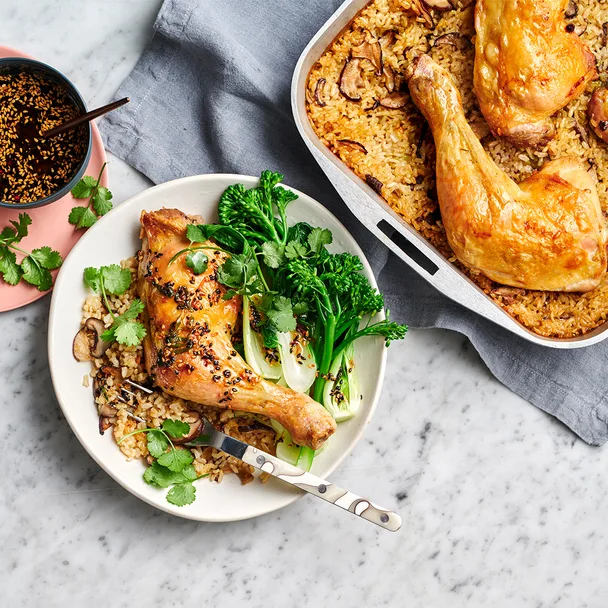 Dish of oven baked chicken with chilli and ginger dressing with side salad.