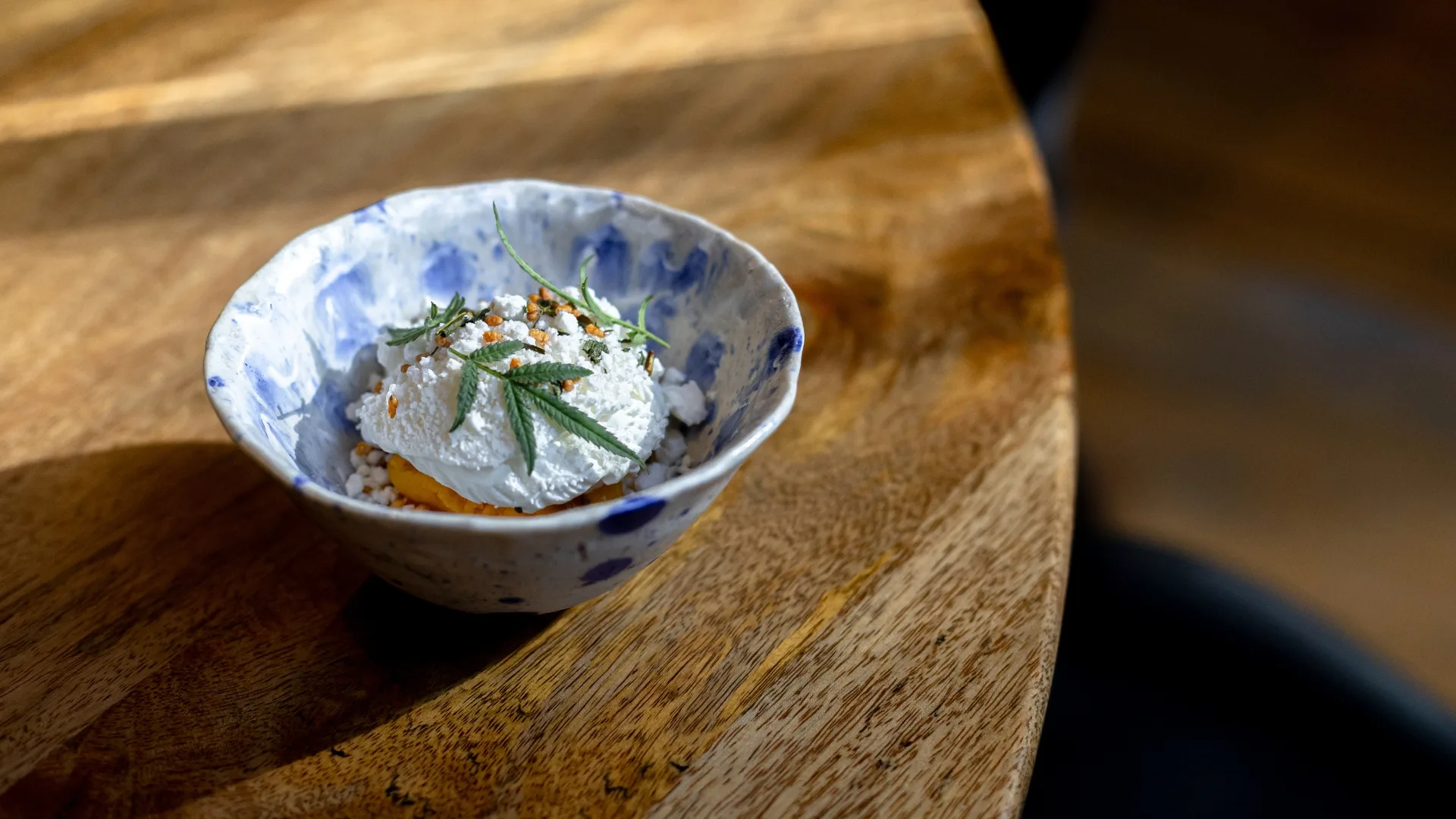 A bowl of dessert on a wooden table at Pneuma.