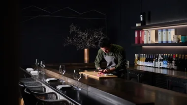 The chef preparing sashimi at the chef's table at Mu Omakase in Canberra