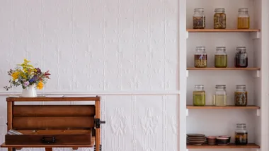 The interiors at Blume showing pickles in jars on shelves.