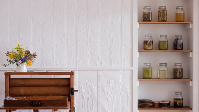 The interiors at Blume showing pickles in jars on shelves.