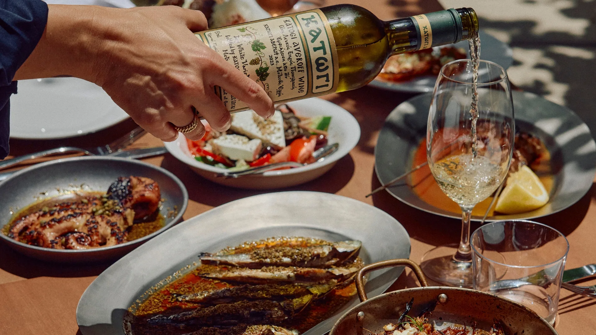 Food and wine being poured at Olympus Dining