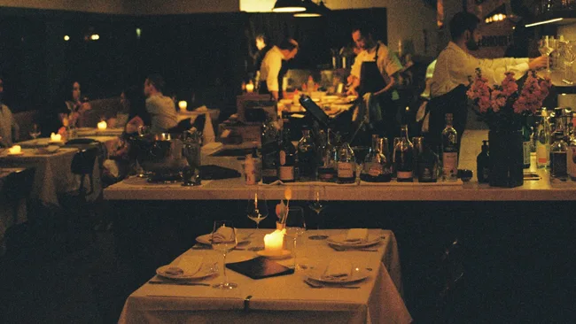 Moody, dim lighting in the dining room of Restaurant Labart in Burleigh Heads, Queensland.