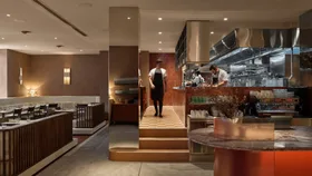 Chef walking in the dining room near the kitchen at Tilda - a new Sydney restaurant in the Sofitel Wentworth hotel