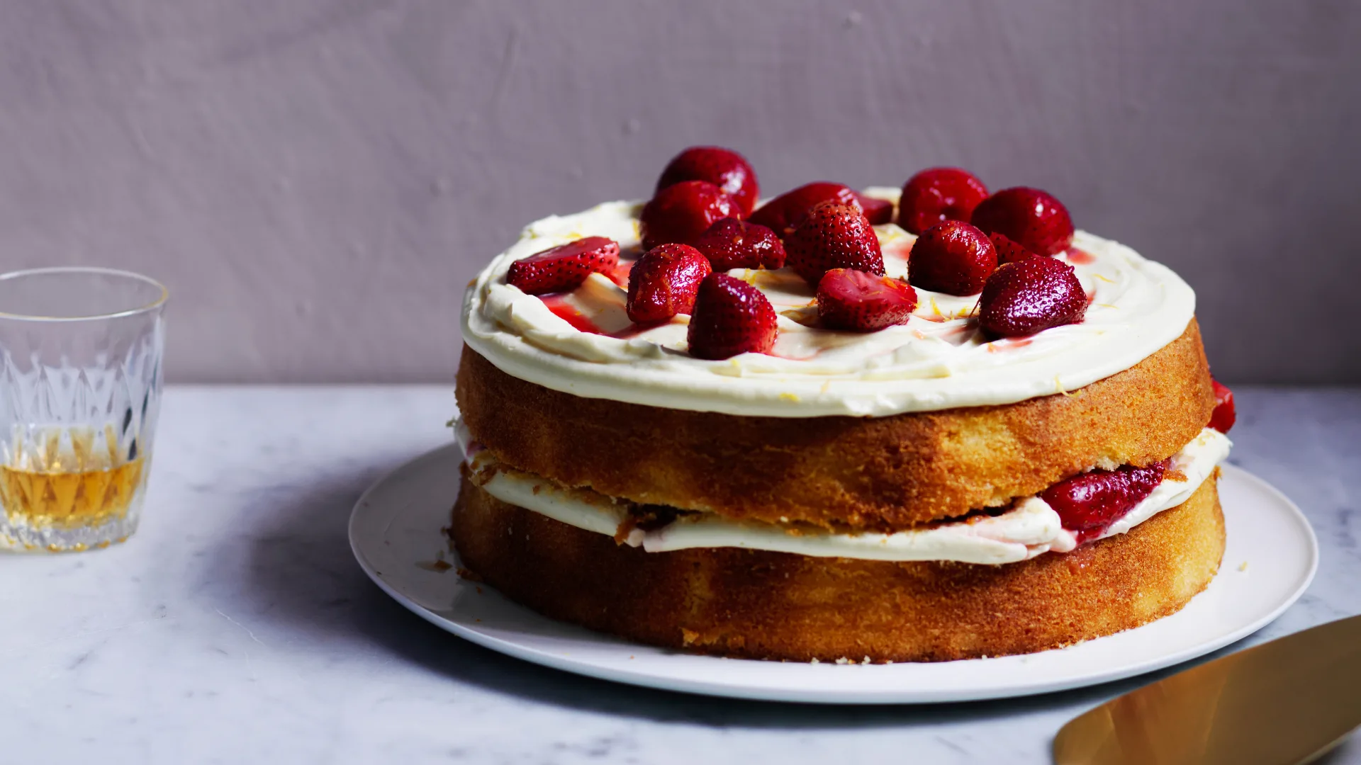 Two layer grapefruit cake with strawberries and cream