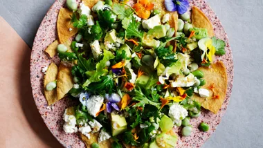 Fried tortillas with broad beans, feta and lime