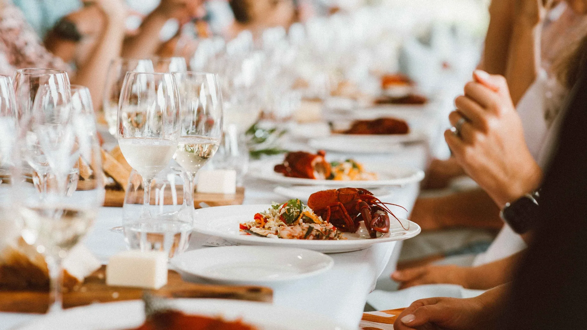 Shot of a dining table with glasses of wine and lobster