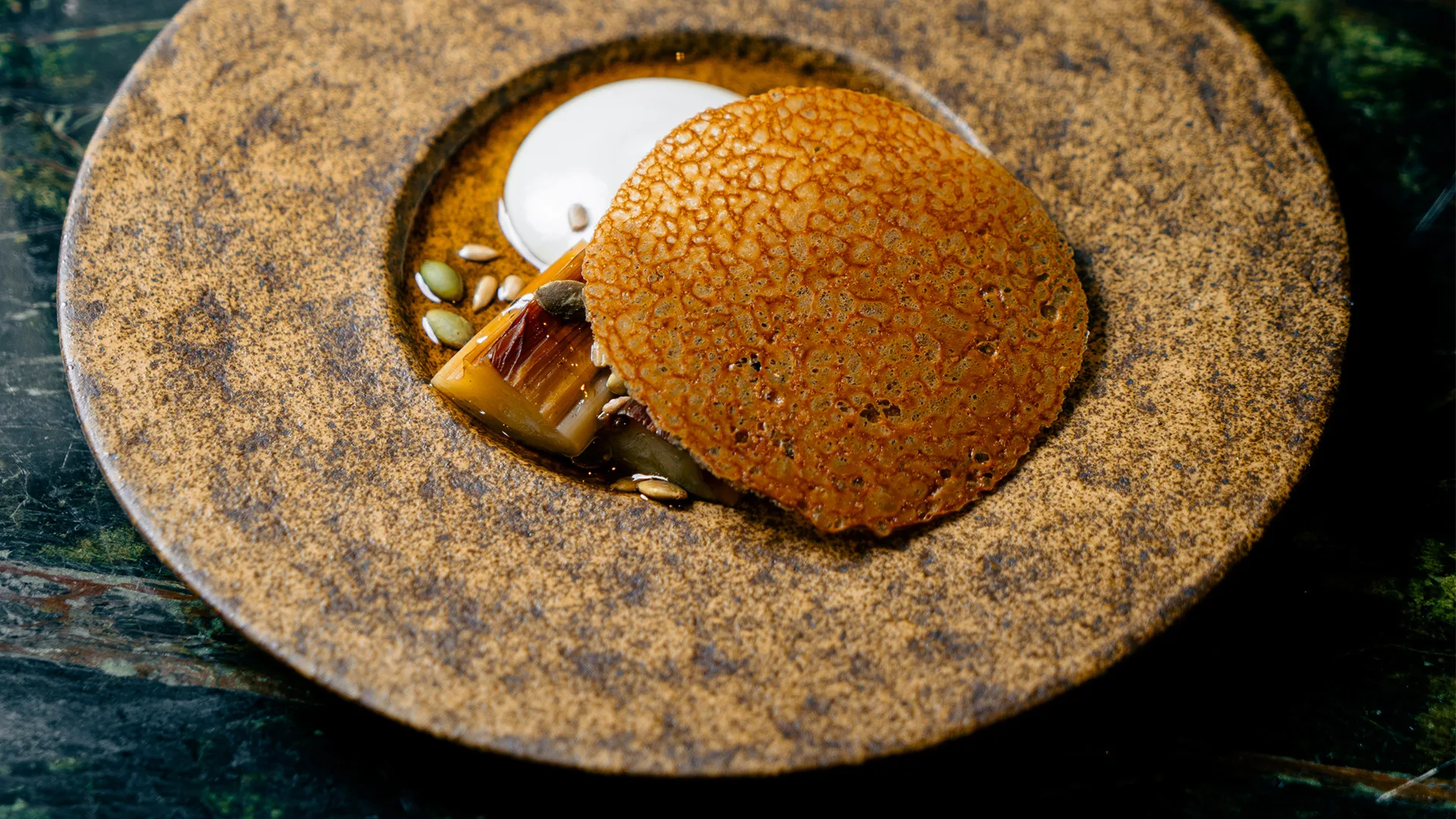 Doju's burnt leek, chicken skin crisp, cashew cream, brown butter.